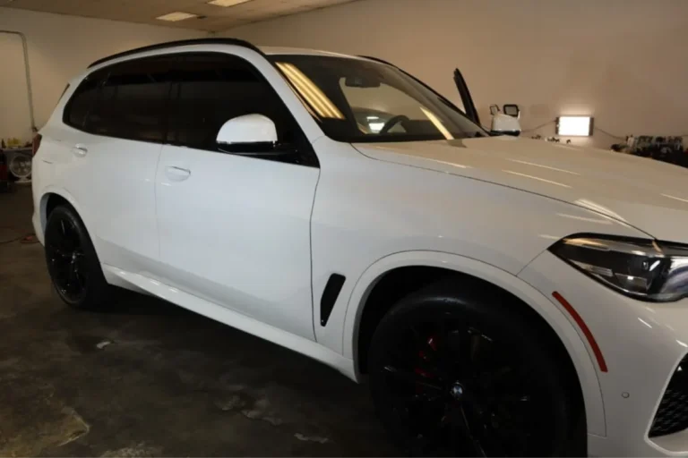White BMW X5 with ceramic coating in a workshop