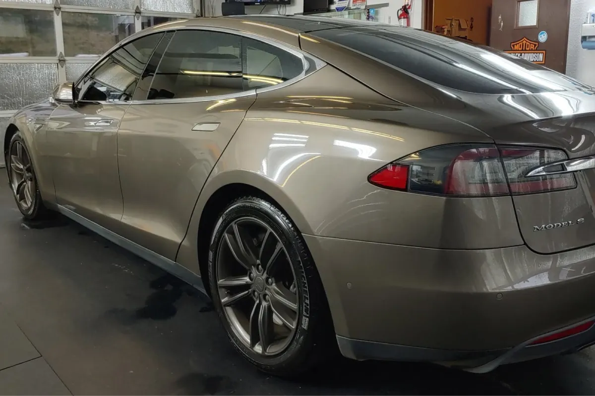 Tesla Model S with paint protection film in a detailing shop.